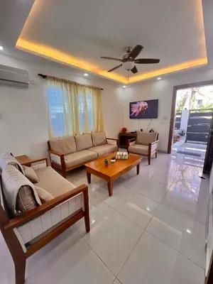 a living room with a couch and a table at Popsy Villa 3 Bedrooms with Pool in Puerto Plata