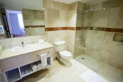 a bathroom with a toilet sink and a shower at Viva Heavens by Wyndham, A Trademark All Inclusive in San Felipe de Puerto Plata