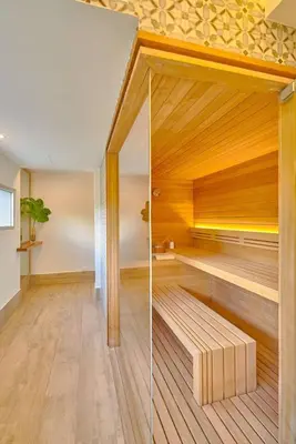 a room with a sauna with a wooden wall at Beachfront FL21 Con Tina Aquarella in La Puntica de Juan Dolio