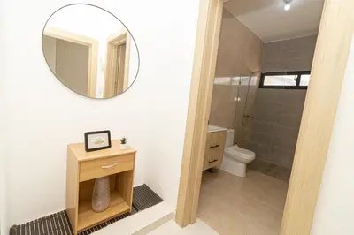 a bathroom with a mirror and a toilet at Cozy 1-BR Apartment in Sunshine Bayahibe in San Rafael del Yuma