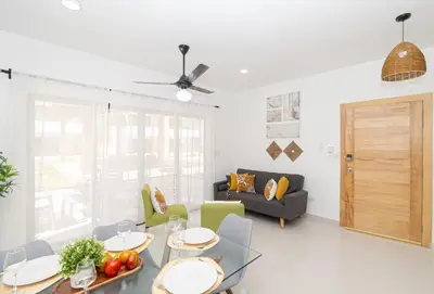 a living room with a table and a couch at Cozy 1-BR Apartment in Sunshine Bayahibe in San Rafael del Yuma