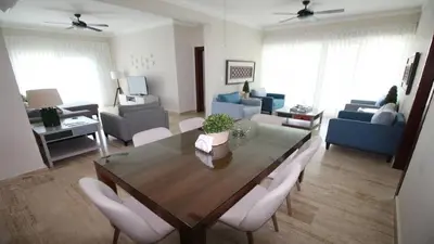 a living room with a dining room table and chairs at Villa Serenity In The Sun in Sosúa