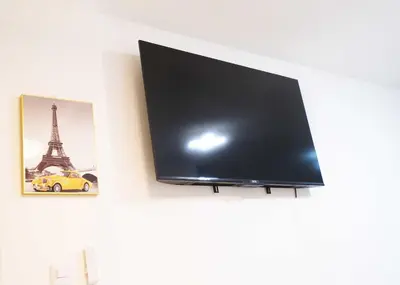 a flat screen tv hanging on a wall at Peace Place in Santiago de los Caballeros