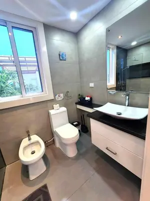 a bathroom with a white toilet and a sink at Unique 3 Bedrooms Villa las Palmas 41 in Puerto Plata