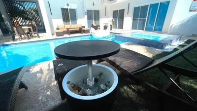 a black table next to a swimming pool with a table at Unique 3 Bedrooms Villa las Palmas 41 in Puerto Plata