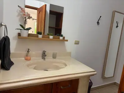 a bathroom with a sink and a mirror at Guest House Canephora in Las Galeras in Las Galeras