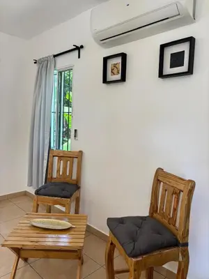 a room with two chairs and a table and a window at Guest House Canephora in Las Galeras in Las Galeras