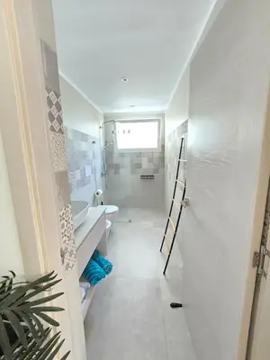 a white bathroom with a toilet and a sink at Margarita 102 Private Beach Access Aqua Esmeralda Dominicus in La Laguna