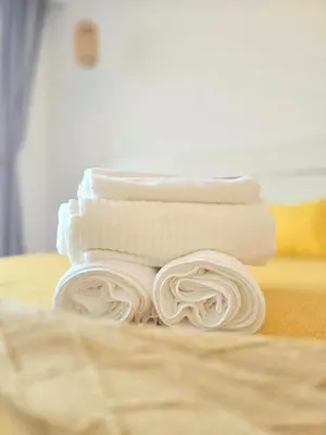 a stack of white towels sitting on a table at Margarita 102 Private Beach Access Aqua Esmeralda Dominicus in La Laguna