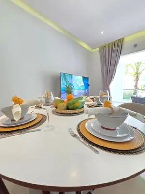 a white table with plates and bowls of fruit on it at Margarita 102 Private Beach Access Aqua Esmeralda Dominicus in La Laguna