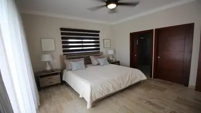 a bedroom with a bed and a ceiling fan at Villa Serenity In The Sun in Sosúa