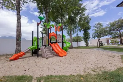 a playground in a park with a slide at The beach, my happy place- One bedroom Apartment in Puerto Plata
