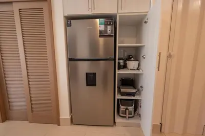 a stainless steel refrigerator in a kitchen at The beach, my happy place- One bedroom Apartment in Puerto Plata