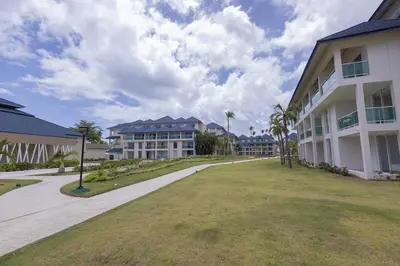 a walkway in front of a large building at The beach, my happy place- One bedroom Apartment in Puerto Plata