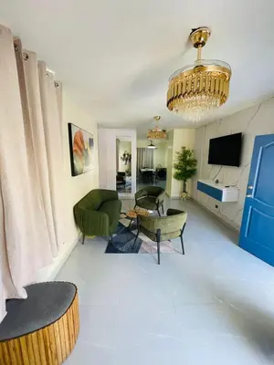a living room with a couch and a chandelier at Luxury apartment near Jumbo in San Pedro de Macorís