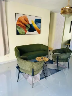 a living room with two chairs and a couch and a table at Luxury apartment near Jumbo in San Pedro de Macorís