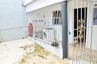 a white fence with a dog in it at Yolanda's house in Bayaguana