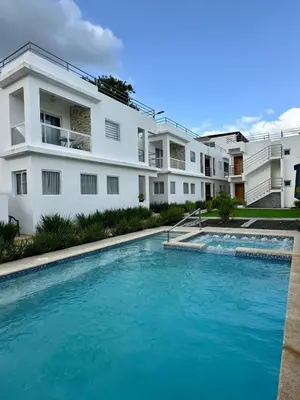 a large swimming pool in front of a building at Apartamento en La Romana buena vista norte Jacuzzi in La Romana