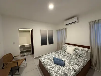 a bedroom with a bed with a blue bag on it at Apartamento en La Romana buena vista norte Jacuzzi in La Romana