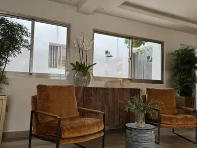 two chairs and a table in a room with windows at Caonabo35 Elegancia Boutique en Santo Domingo1 in Santo Domingo