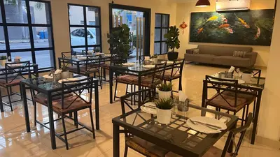 a dining room with tables and chairs and a couch at Caonabo35 Elegancia Boutique en Santo Domingo1 in Santo Domingo