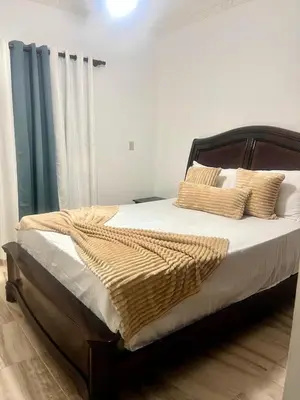 a bedroom with a large bed with white sheets and pillows at Beautiful and confortable apt in Puerto Plata