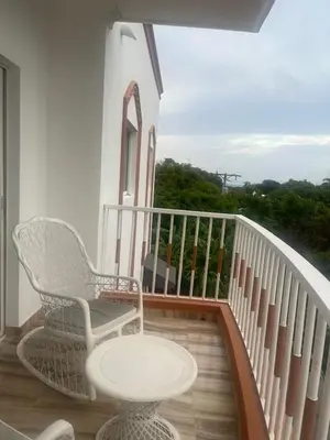 a balcony with a table and a chair and a table at Beautiful and confortable apt in Puerto Plata