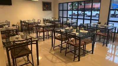 a group of tables and chairs in a restaurant at Caonabo35 Elegancia Boutique en Santo Domingo 2 in Santo Domingo
