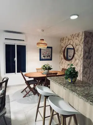 a kitchen and dining room with a table and chairs at Experience Coconut Paradise Apart O2 in San Cristóbal