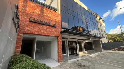a red brick building with a sign on it at Caonabo35 Elegancia Boutique en Santo Domingo 3 in Santo Domingo