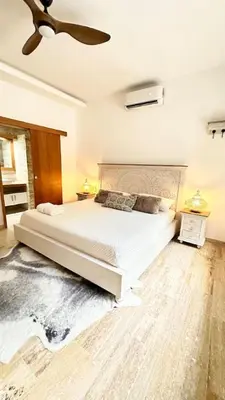 a bedroom with a large white bed and a ceiling at Casa Las Ballenas - 3 bedroom Las Terrenas in Las Terrenas