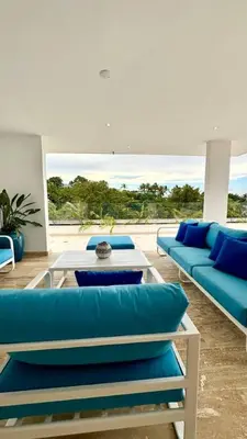 a living room with blue couches and a table at Casa Las Ballenas - 3 bedroom Las Terrenas in Las Terrenas