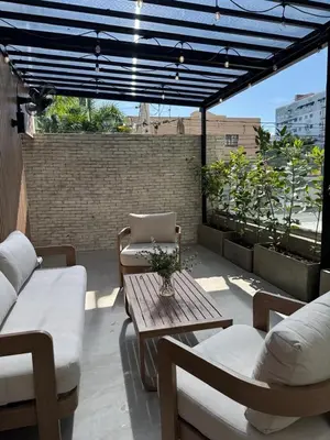 a patio with a table and chairs on a roof at Caonabo35 Elegancia Boutique en Santo Domingo 5 in Santo Domingo
