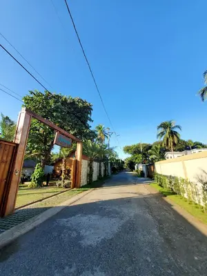 an empty street with an open door to a building at Serendipia Hotel Nizao in Nizao