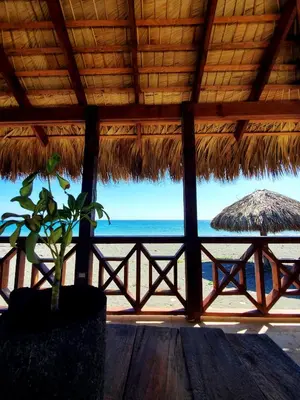 a view of the beach from a straw hut at Serendipia Hotel Nizao in Nizao