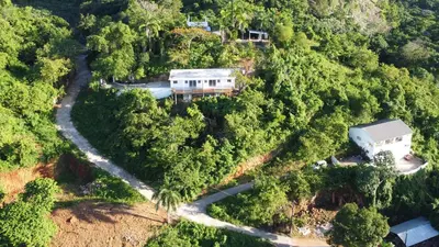 an aerial view of a house in the middle of a forest at Endless Horizon Apartments in Las Terrenas