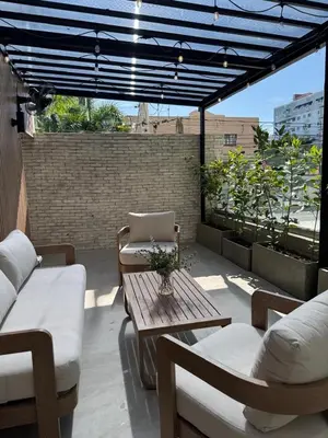 a patio with a table and chairs on a roof at Caonabo35 Elegancia Boutique en Santo Domingo 6 in Santo Domingo