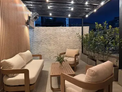 a patio with chairs and a table and lights at Caonabo35 Elegancia Boutique en Santo Domingo 7 in Santo Domingo