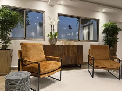 two chairs and a table in a room with windows at Caonabo35 Elegancia Boutique en Santo Domingo 8 in Santo Domingo