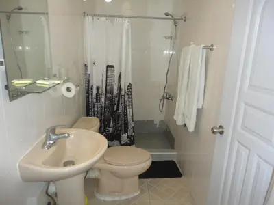 a bathroom with a toilet and a sink and a shower at Hotel Gazcue in Santo Domingo