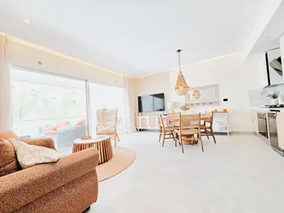 a living room with a couch and a table at Dominica 203 Luxury Apartment by Caribbean Beach Dominicus Aqua Esmeralda in Bayahibe
