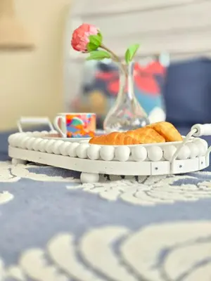 a tray of bread and a vase on a table at Dominica 203 Luxury Apartment by Caribbean Beach Dominicus Aqua Esmeralda in Bayahibe