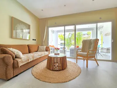 a living room with a couch and a table at Dominica 203 Luxury Apartment by Caribbean Beach Dominicus Aqua Esmeralda in Bayahibe