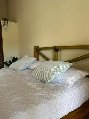 a bed with two pillows on top of it at Guest-Room 2 Palmeras - 2 Pax, 5 Min de La Playa in Las Galeras