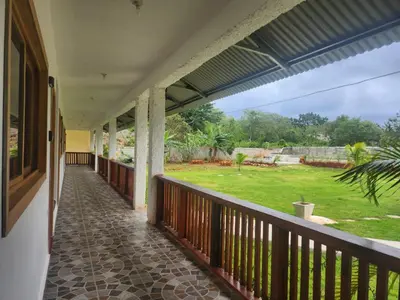 a porch of a house with a view of a yard at Dani's Guesthouse in Las Galeras