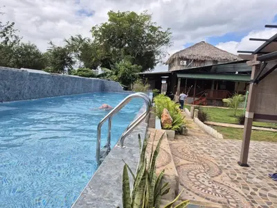a swimming pool next to a house at Dani's Guesthouse in Las Galeras