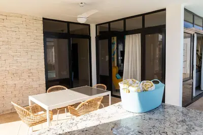 a patio with a table and chairs and a bucket of chips at Newly built 2 bedroom 2 bath private pool villa! in Sosúa