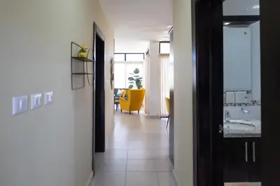 a hallway with a yellow chair in a room at Newly built 2 bedroom 2 bath private pool villa! in Sosúa