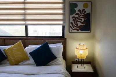 a bedroom with a bed with a window and a lamp at Newly built 2 bedroom 2 bath private pool villa! in Sosúa
