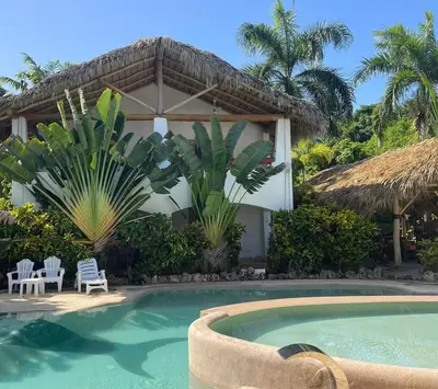 a villa with a swimming pool and a resort at Apartamento La Palmeras - 3 Pax, 5 Min de La Playa in Las Galeras